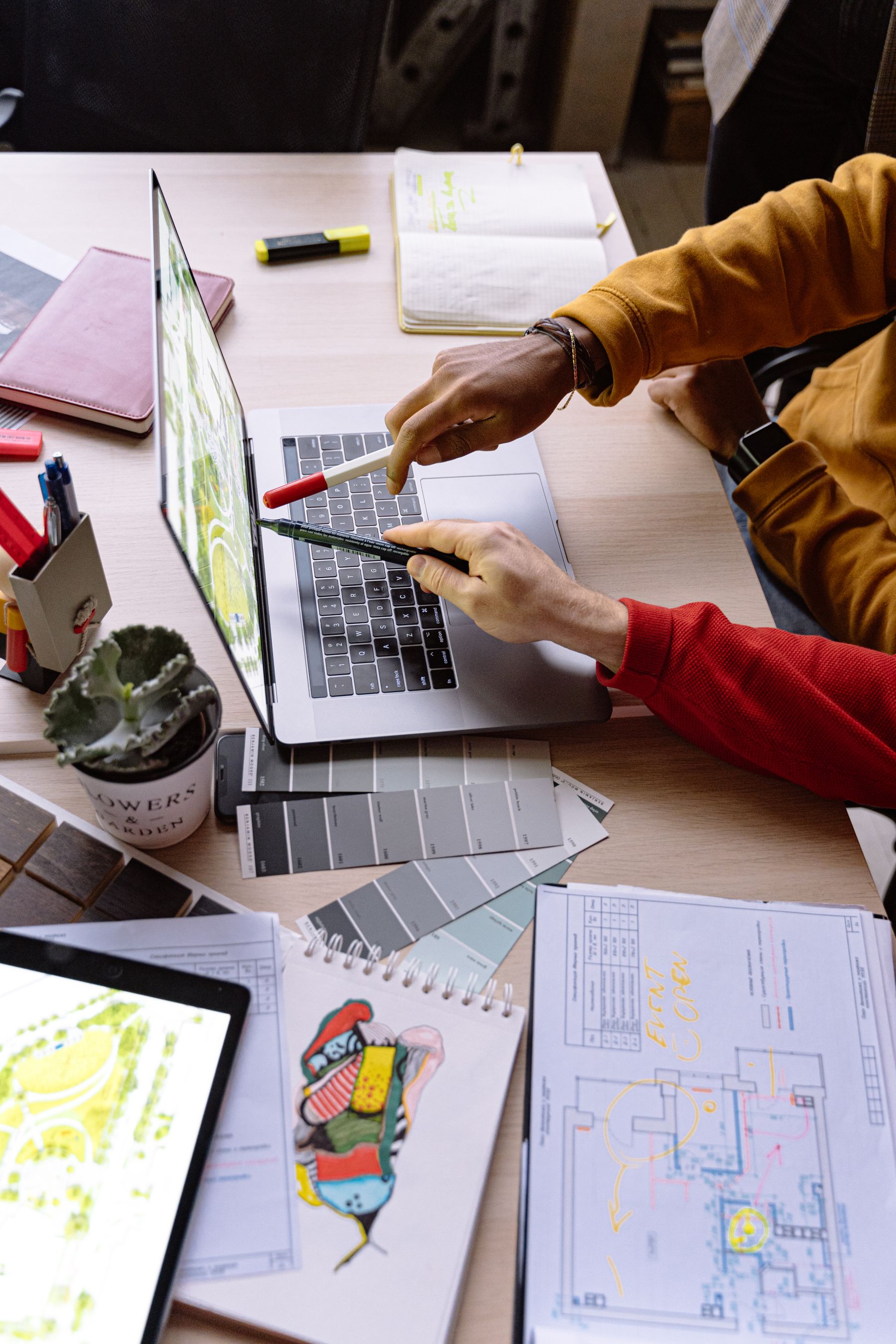 Developers and designers collaborating around a laptop
